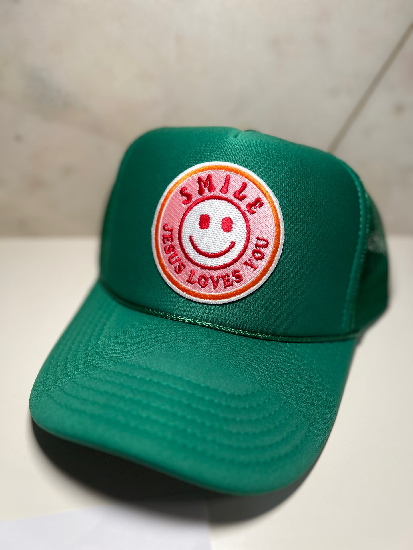 Smile Jesus Loves You on kelly green trucker